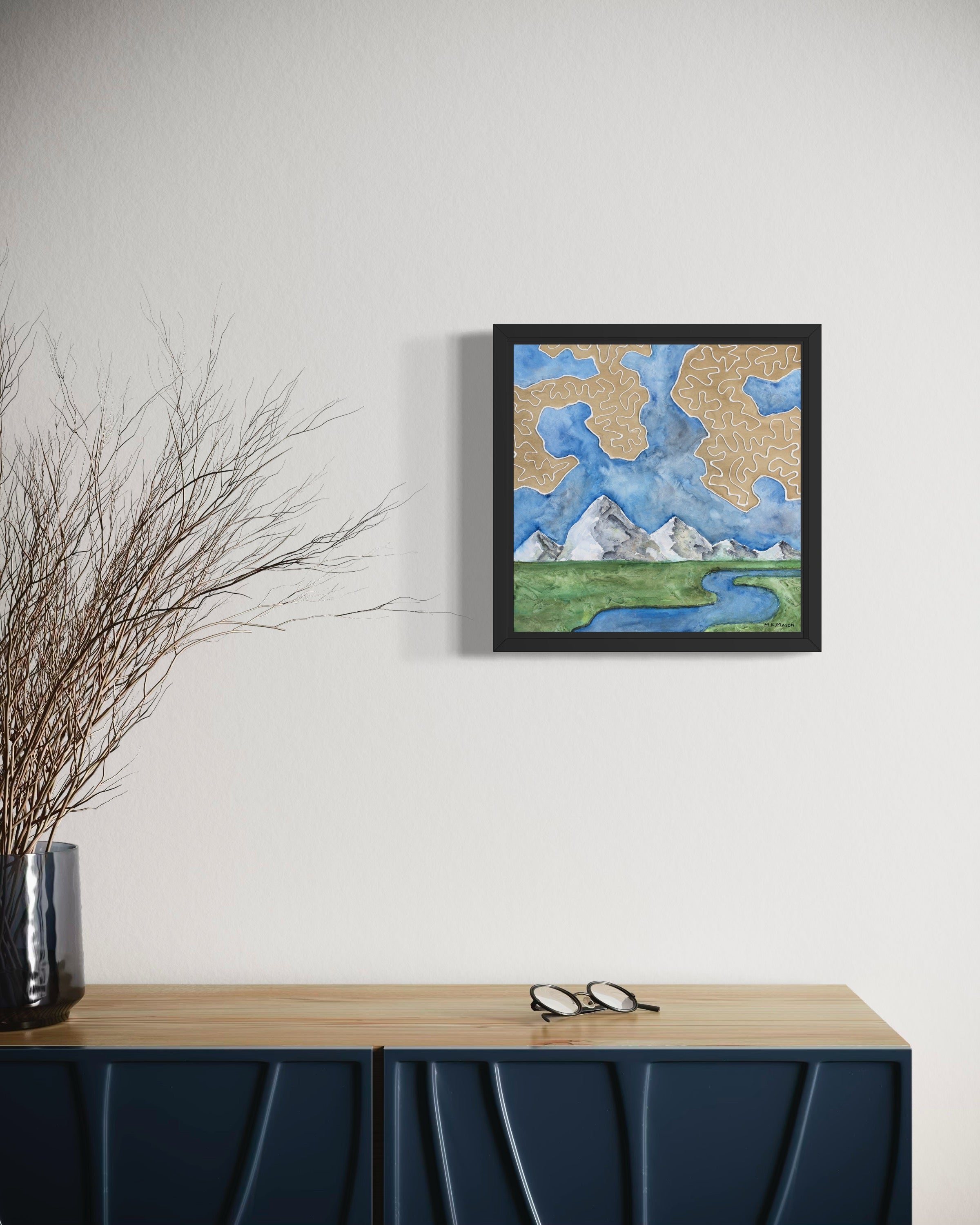 Watercolor landscape featuring a winding river, snowy mountain peaks, green fields, and tan abstract cloud-like patterns, artwork by MK Mason, interior mockup